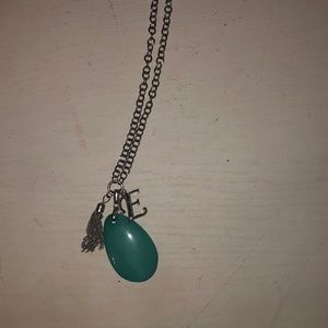 silver necklace with turquoise rock and studded E